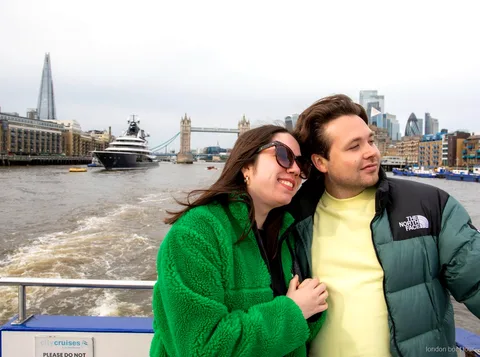 Passageiros a embarcar num barco do cruzeiro hop-on hop-off num cais de Londres no Tâmisa