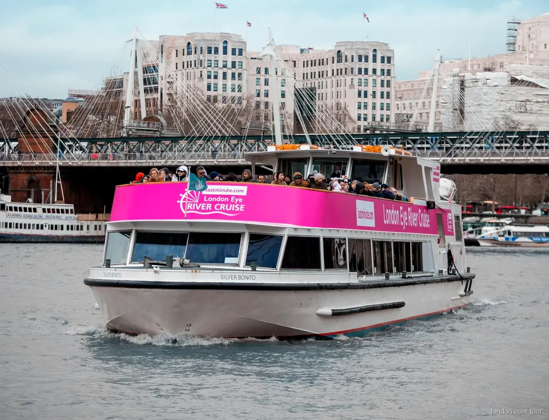 London Eye river cruise boat departing from the pier beneath the London Eye