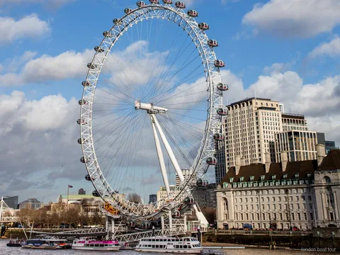 Passengers on a London Eye river cruise boat passing Tower Bridge