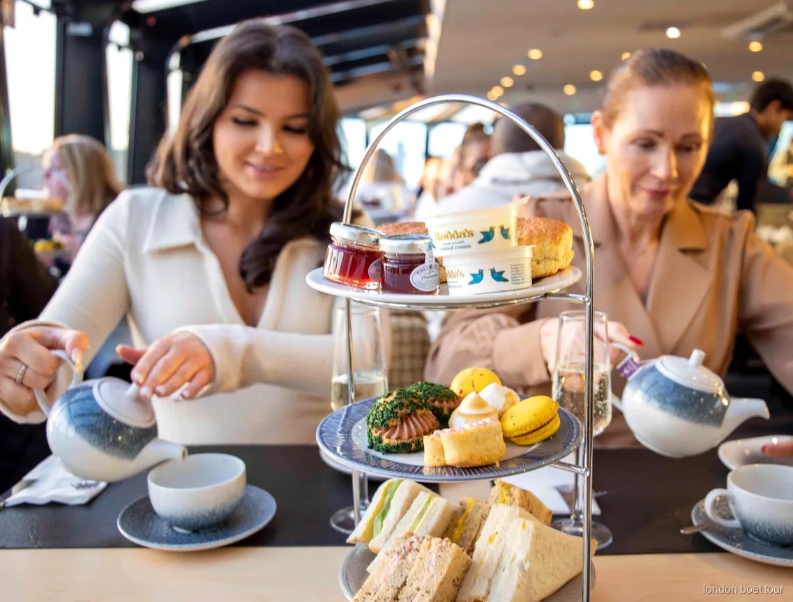 Afternoon tea stand with sandwiches and scones served on a Thames river cruise
