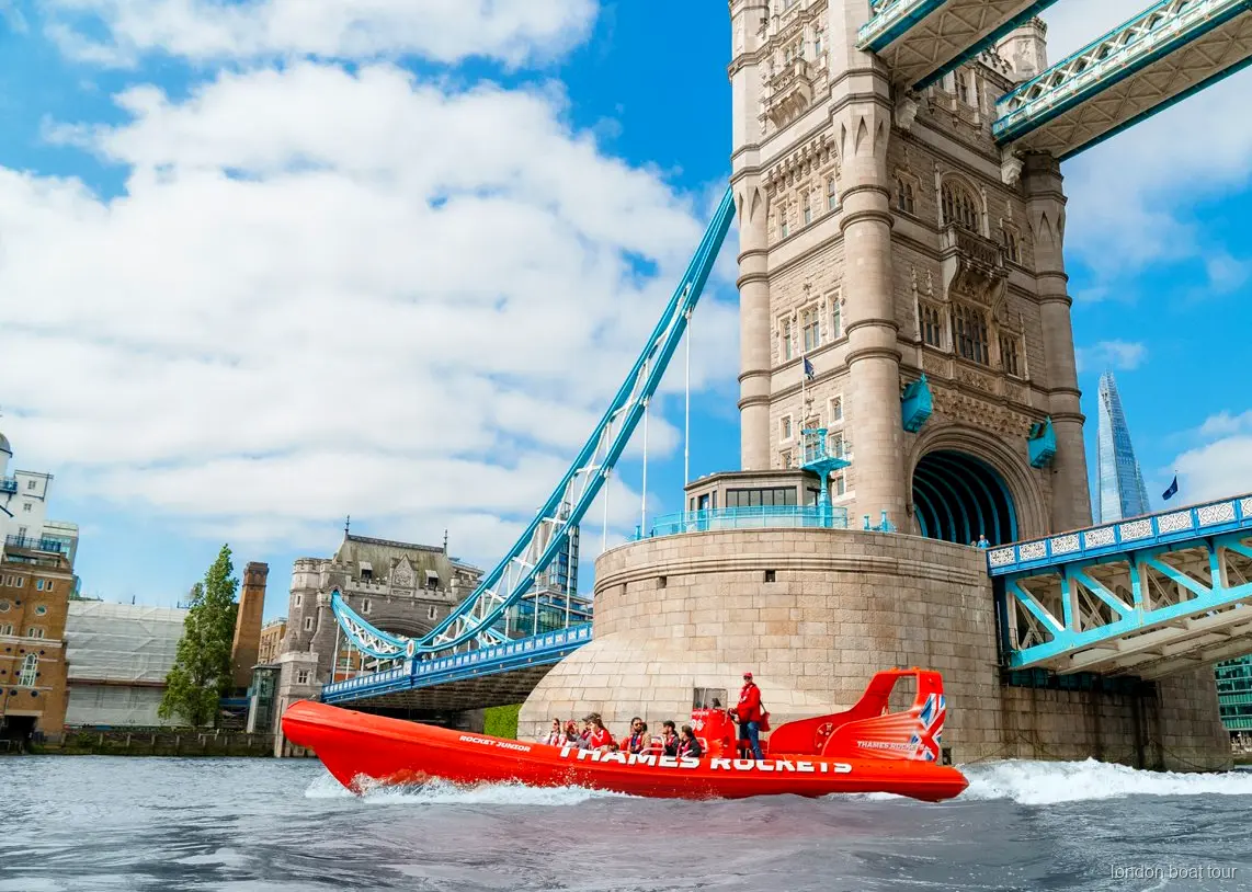 Speedboat tour guide pointing out London landmarks on the River Thames