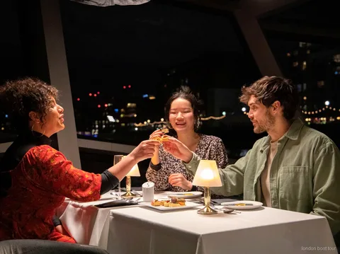 Tafel gedekt voor een 3-gangendiner op een Theems dinercruise 's avonds