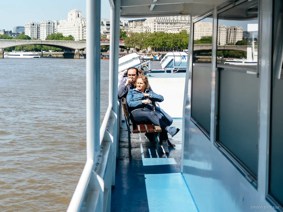 Interior heated saloon seating on a Thames sightseeing cruise boat in London